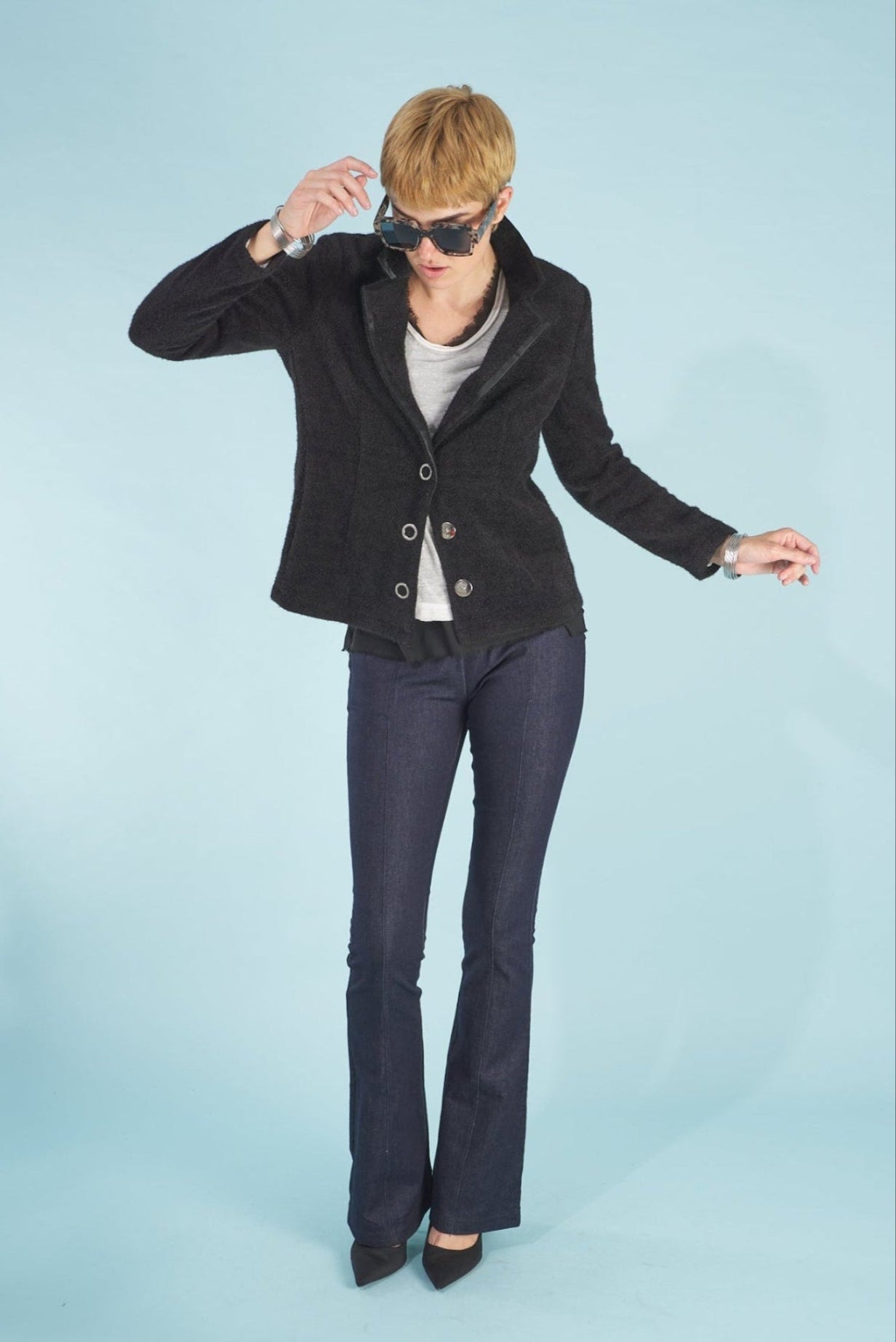 Woman wearing a black austin blazer and sublime jeans by inlarkin on a light blue background