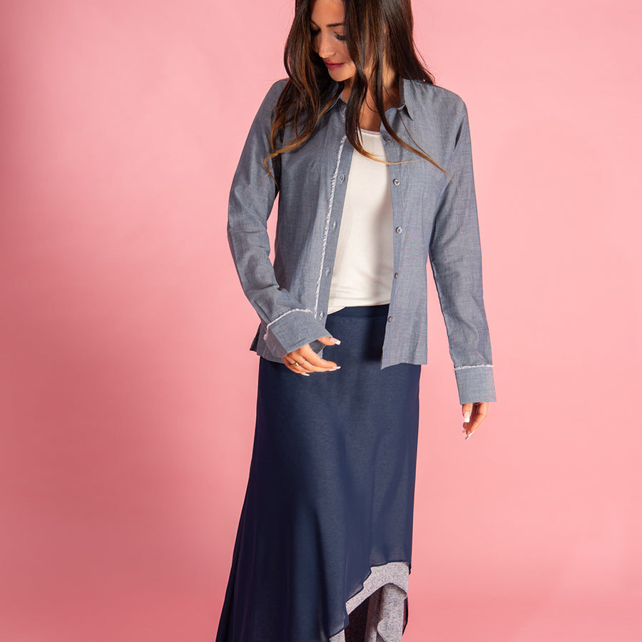 the chemise shirt by inlarkin in blue featuring the raw edged placket down the center and cuffs
