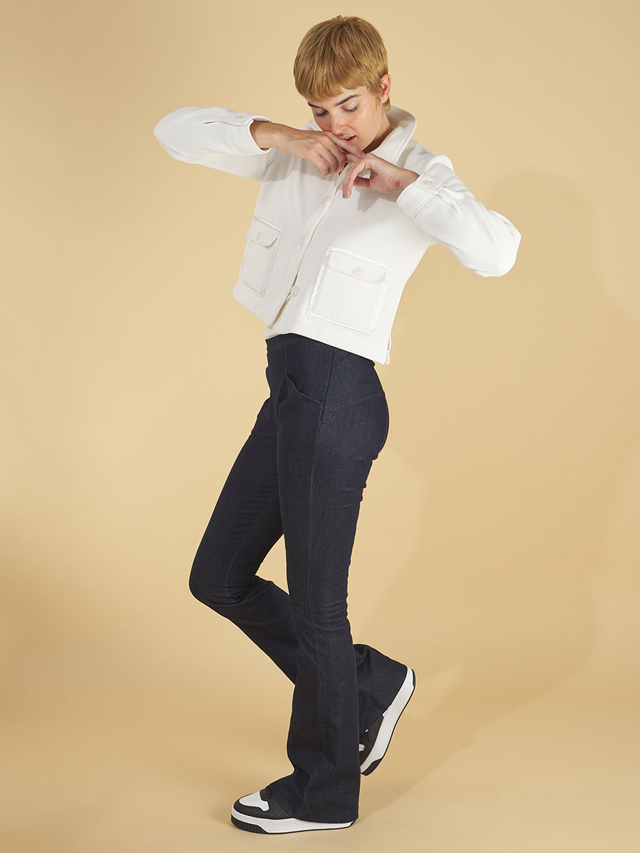 the cropped shirt jacket by inlarkin in white side view featuring the front sea glass buttoned patch pockets, side vent detail and collar paired with the sublime jean by inlarkin