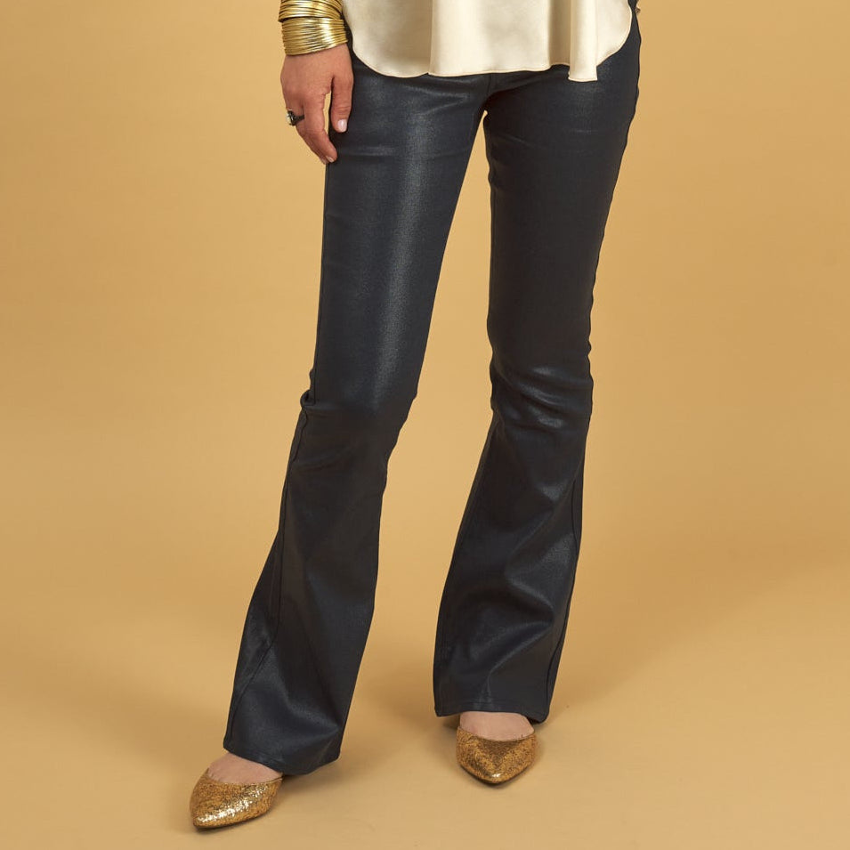 navy gloss curve jean by inlarkin with gold flats on a yellow background