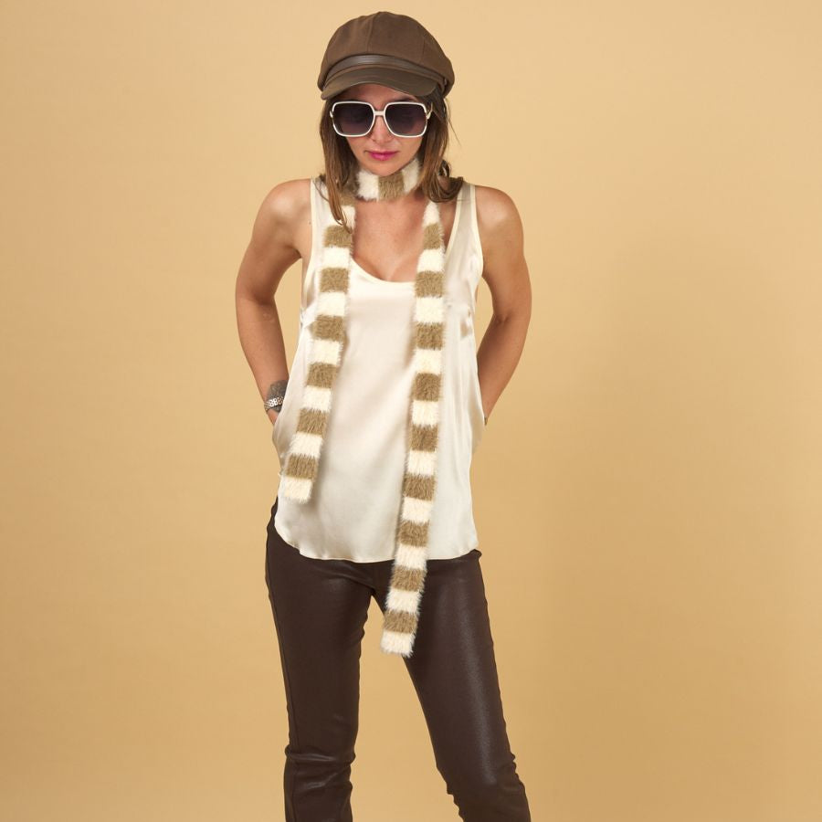 a woman wearing an ecru decuir silk shell by inlarkin with chocolate gloss curve jeans on a yellow background