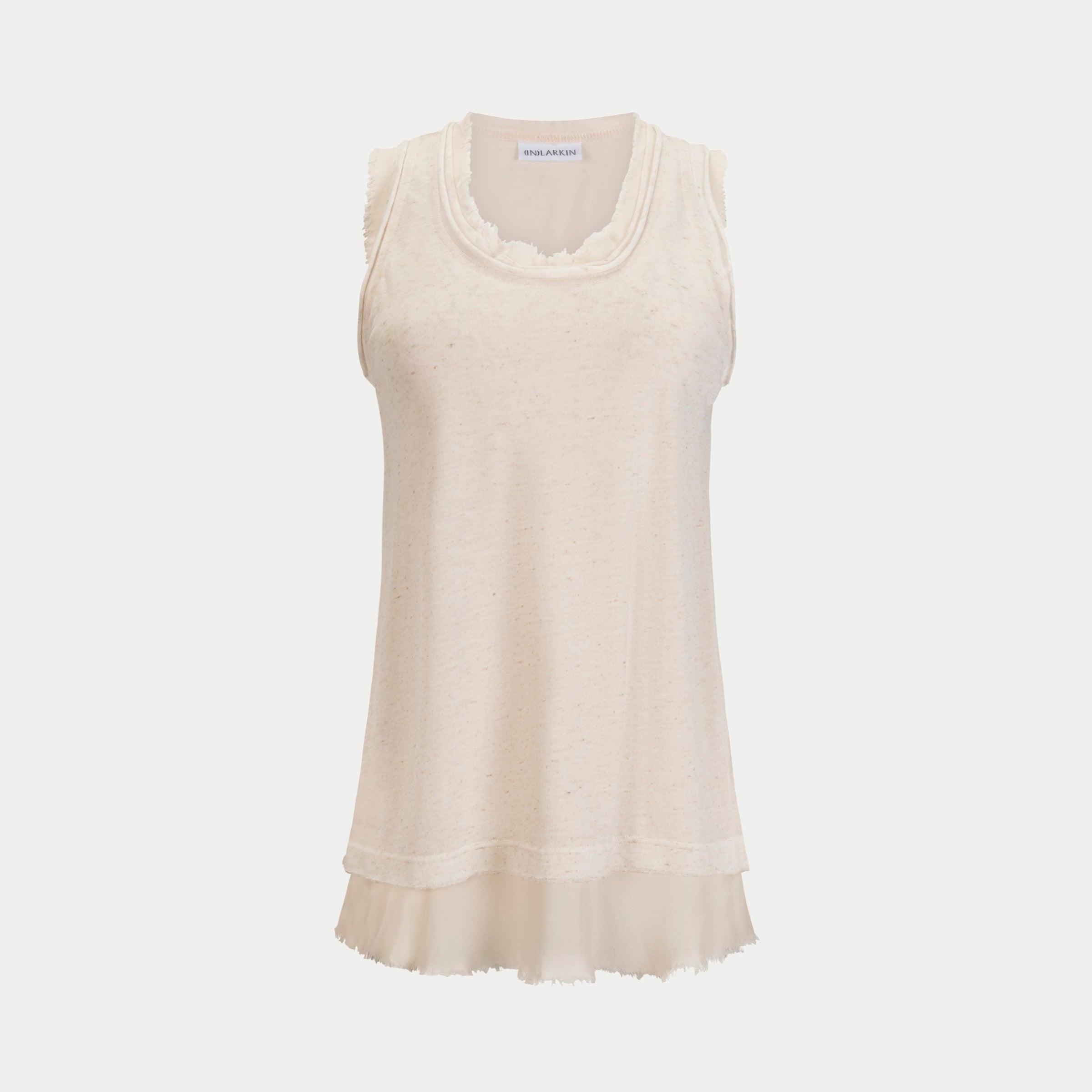 front view of the glasswing shell 2.0 in cream with white by inlarkin showing the detailed raw edge hem at neckline and arm holes