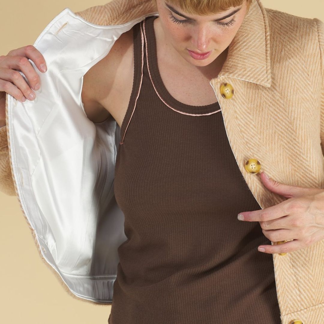the herringbone harriet jacket by inlarkin in coffee showing the sophisticated accents such as sateen trim and sea glass buttons