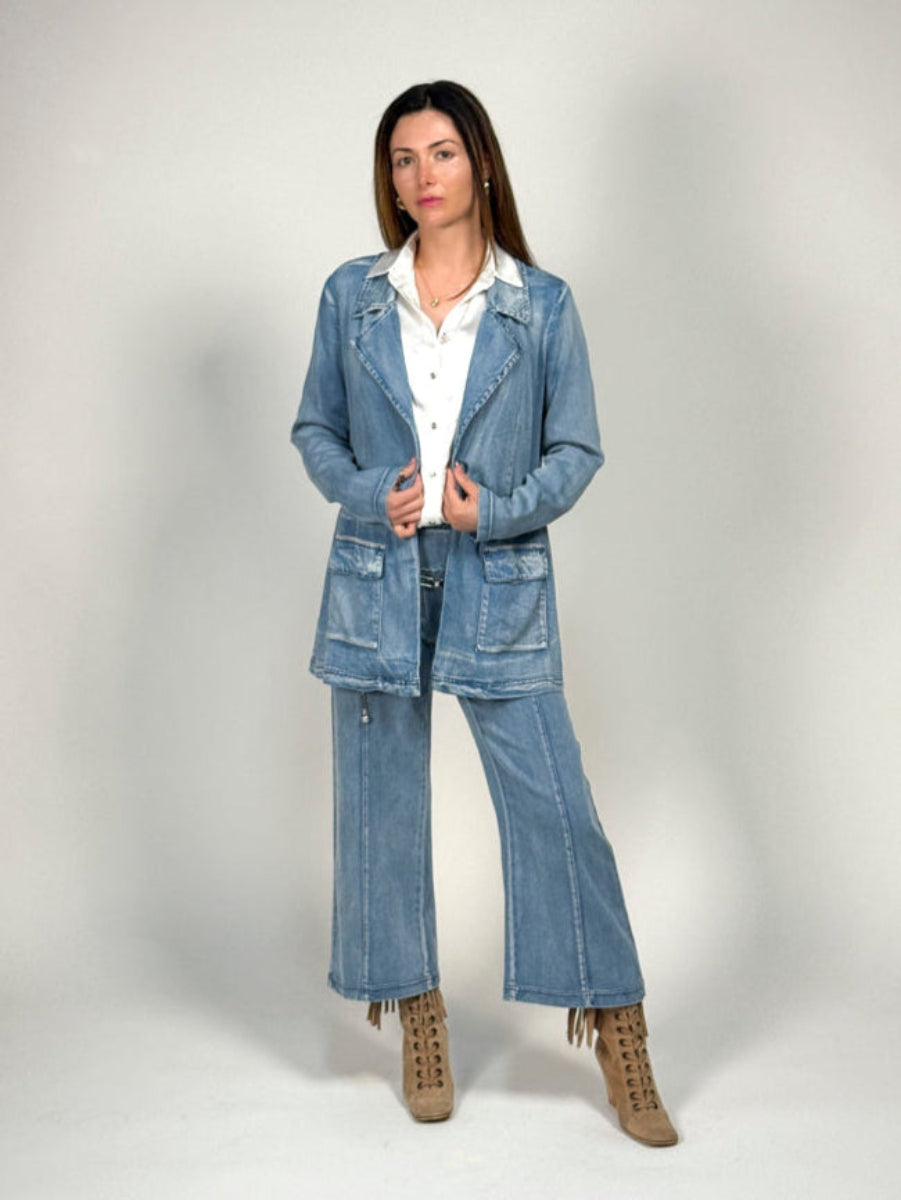 Woman wearing a denim outfit on a plain background