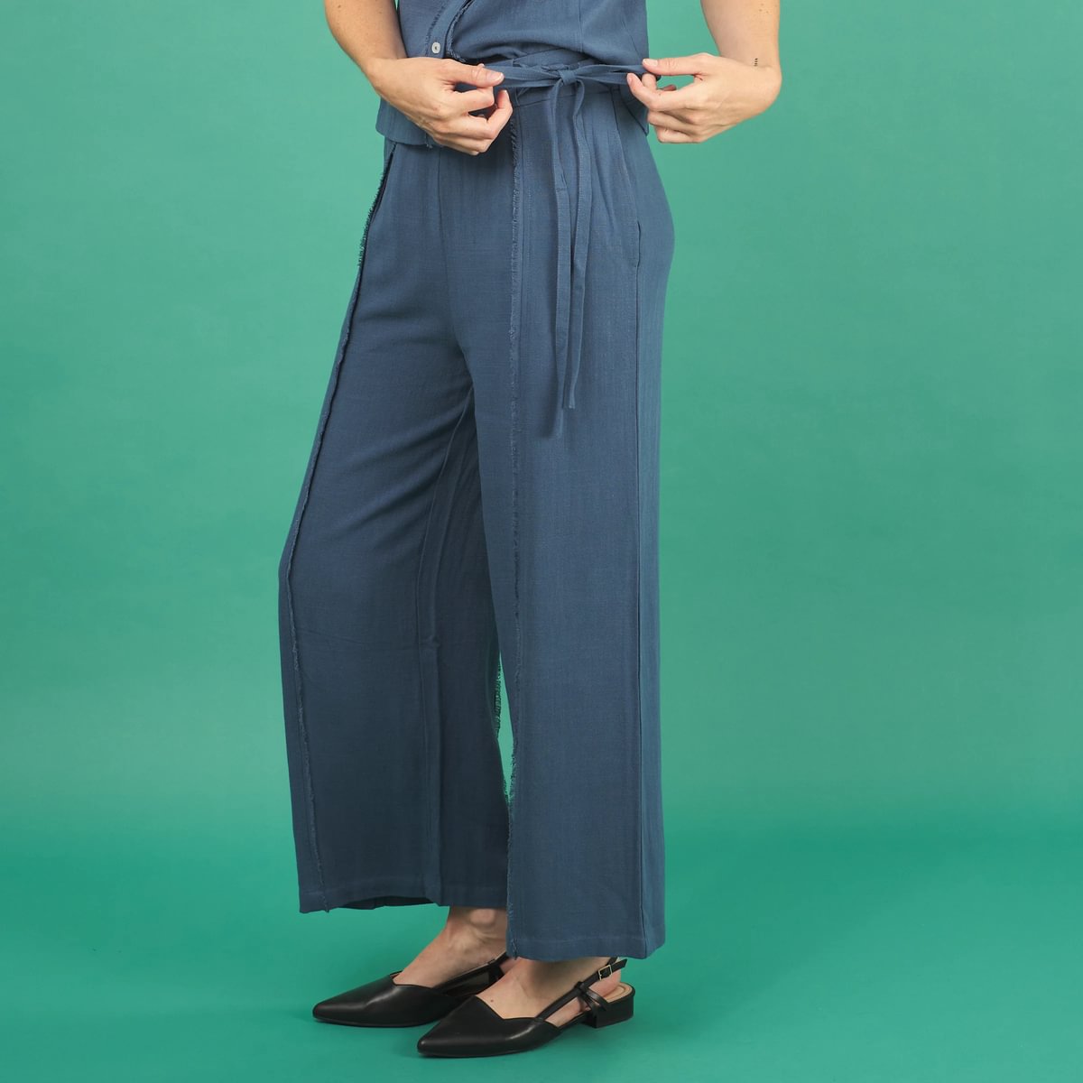 the linen fray pant in french blue front side view with frayed seams, front waistband tie and pockets