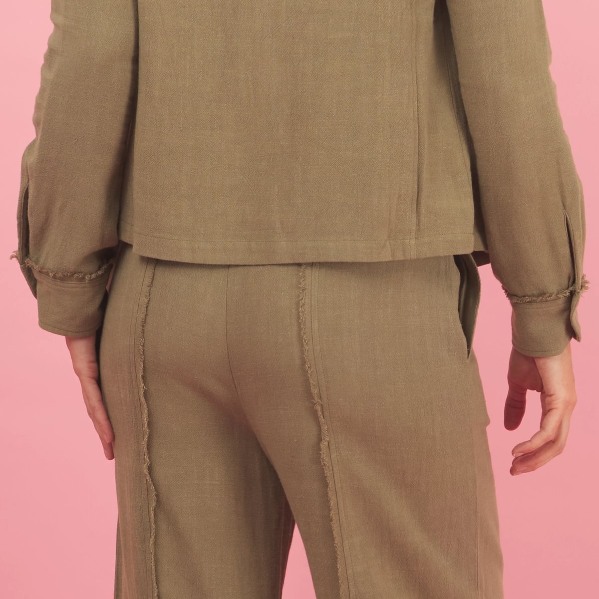 the linen fray pant in green sage back view with frayed seams detail