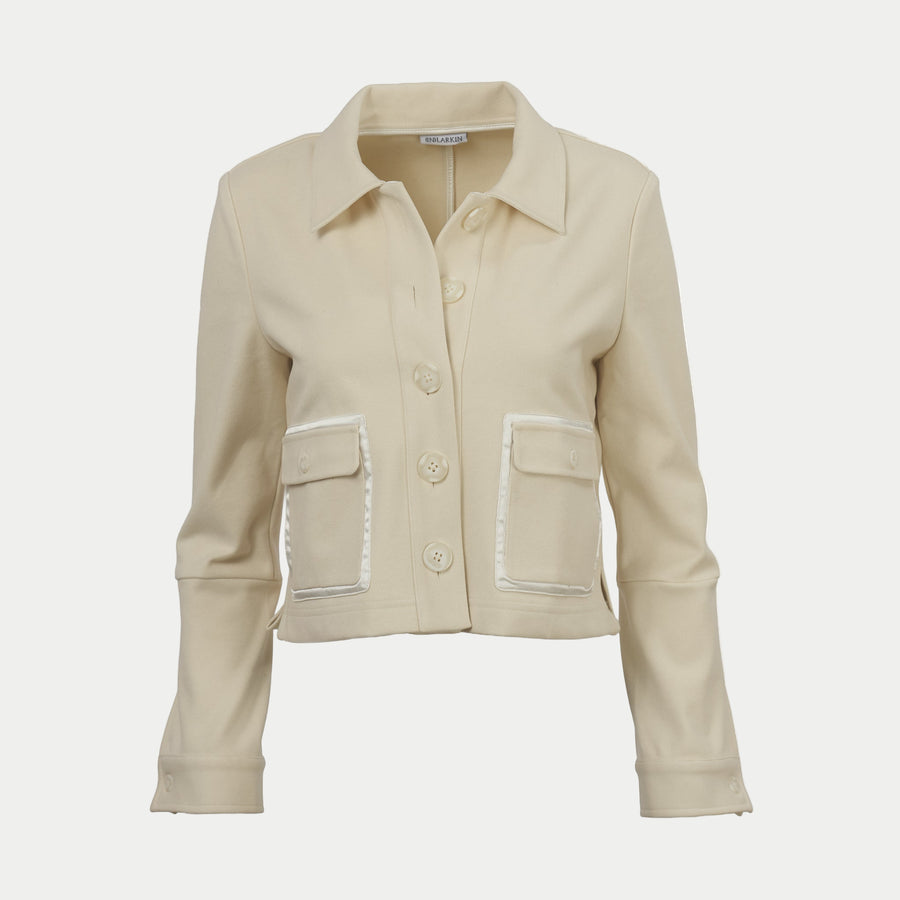 Oak colored shaket crop jacket by inlarkin with button details on an off-white background
