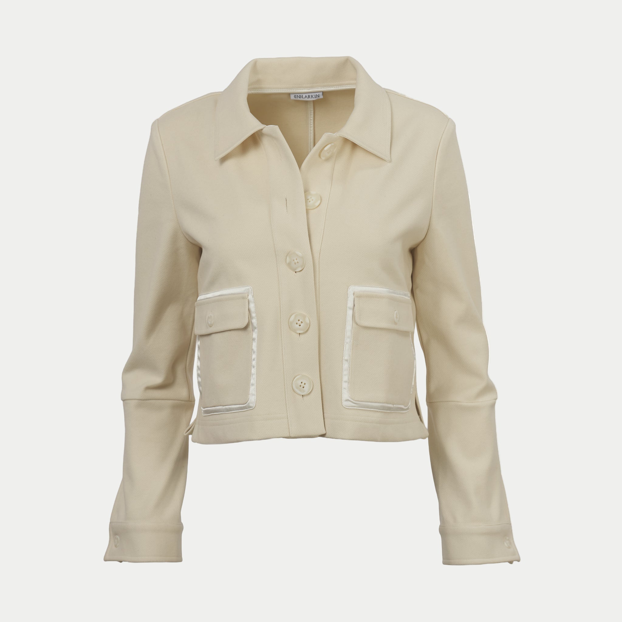 Oak colored shaket crop jacket by inlarkin with button details on an off-white background