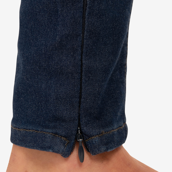 the unreal jean 2.0 by inlarkin dark indigo stretch slimming denim jean pant leg detailing the functioning zipper at inside ankle zipped