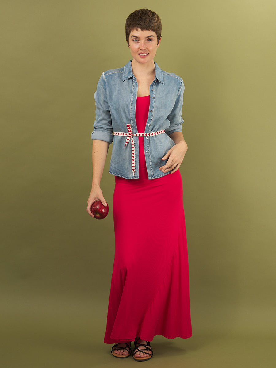 Woman wearing the red sharyn dress with the alex denim jacket by inlarkin on a green background