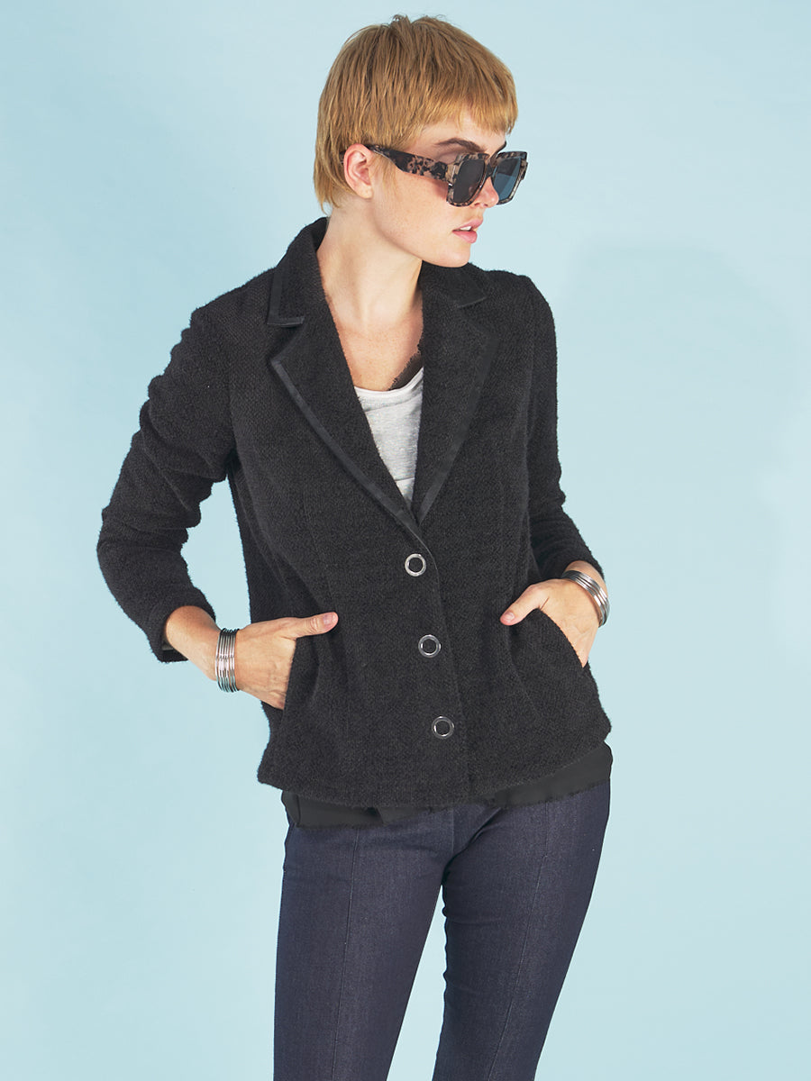 the austin blazer by inlarkin in black front view showing the signature large punch snaps and trimmed collar paired with the sublime jean by inlarkin