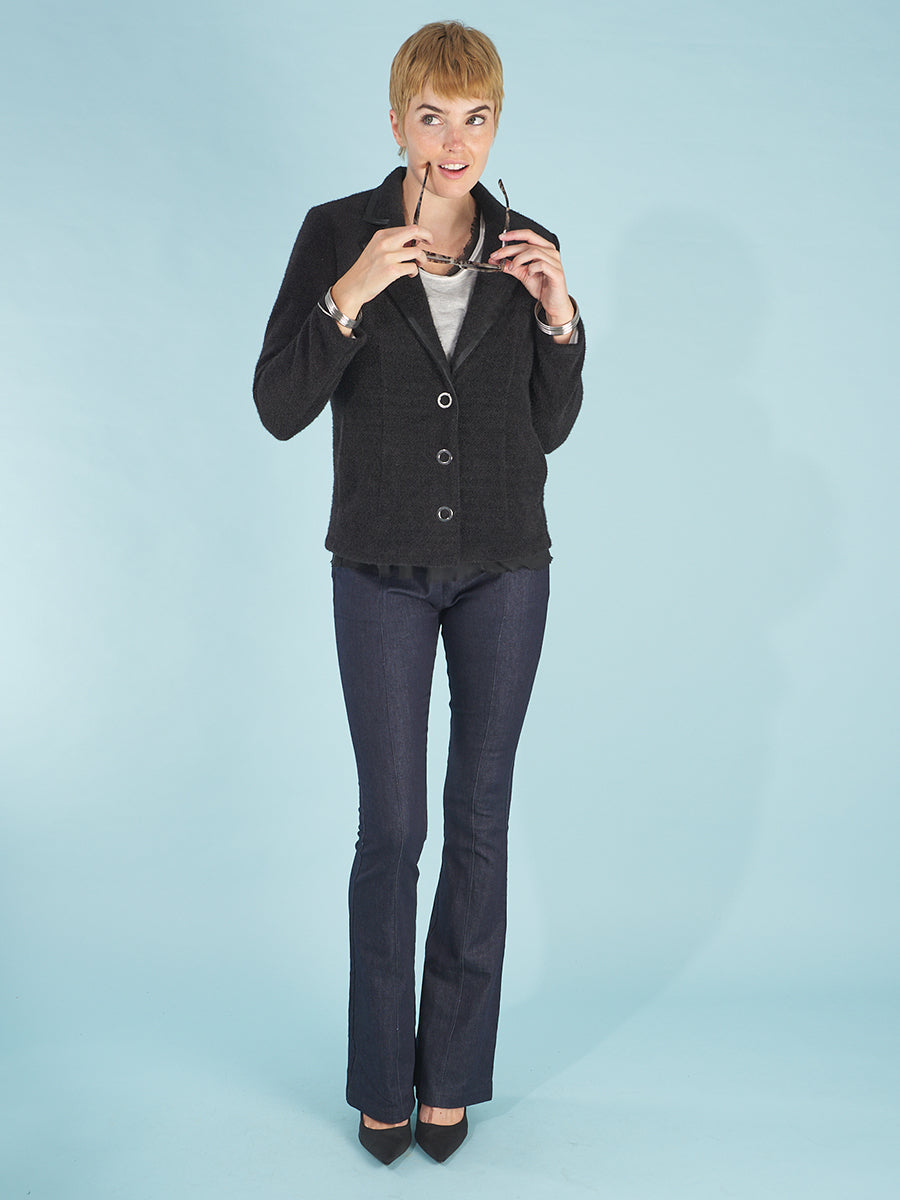 the austin blazer by inlarkin in black front view featuring signature large punch snaps, trimmed collar and bracelet length sleeve, paired with the sublime jean by inlarkin
