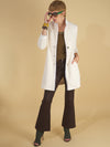 the belle blazer by inlarkin in ivory front view with signature large punch snaps, inverted collar and pockets paired with the gloss bootleg in chocolate by inlarkin