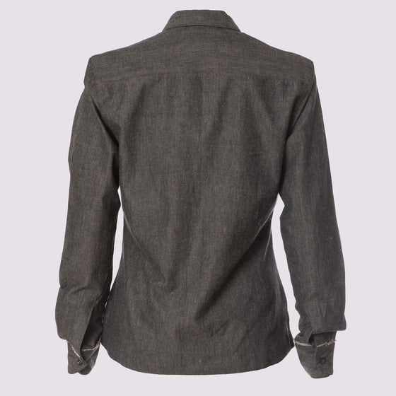 back view of the grey classic updated chemise shirt by inlarkin showing the full length sleeves and raw-edge at cuffs in cotton chambray fabric