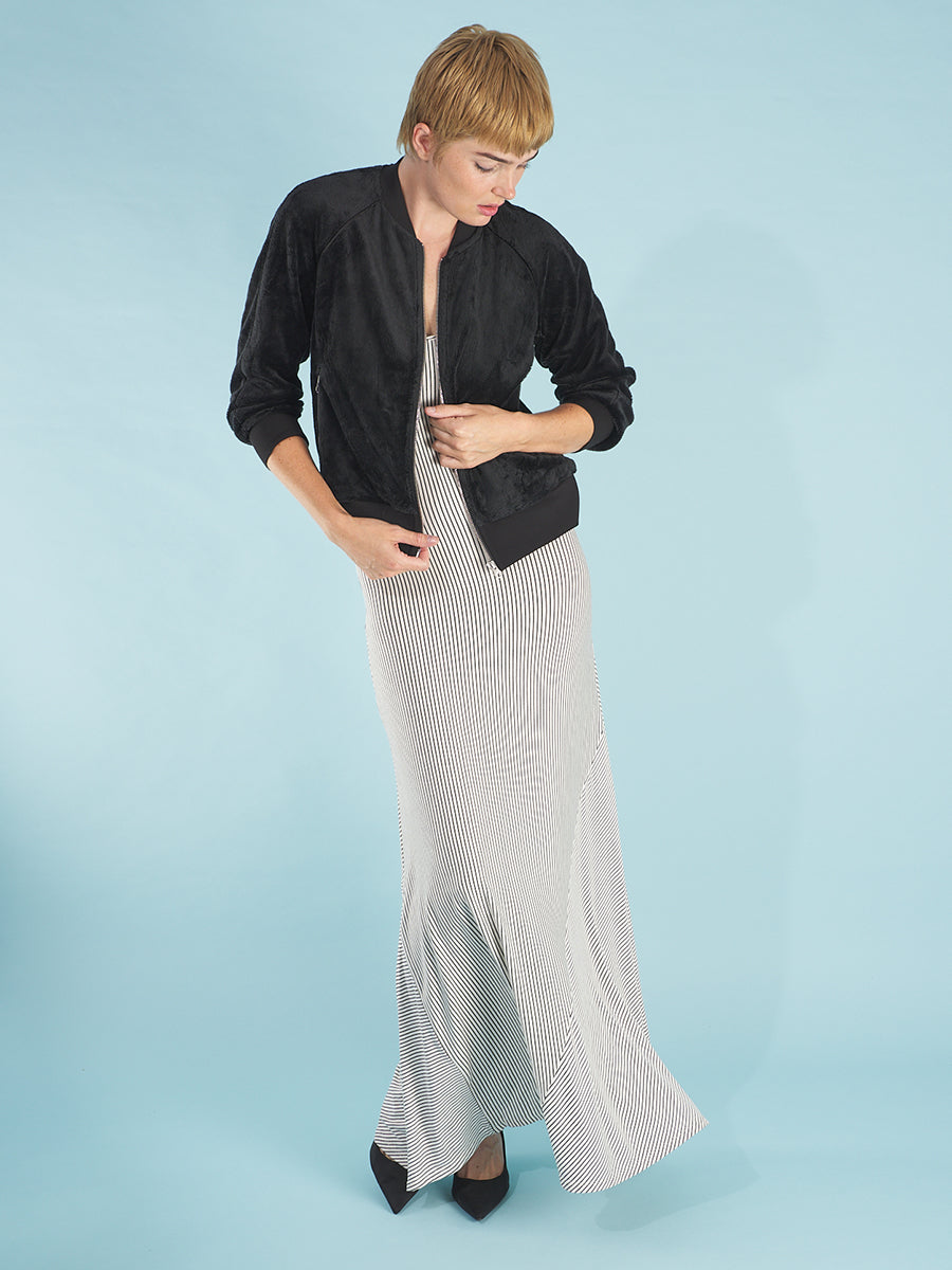 the cody dress in white stripe by inlarkin front view featuring the form flattering fit paired with the paris beauty bomber 