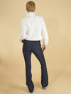 the cropped shirt jacket by inlarkin in white back view detail showing the collar, back seam and buttoned cuffs