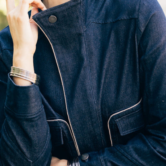 woman wearing the denim debra jean jacket by inlarkin showing the details of the design