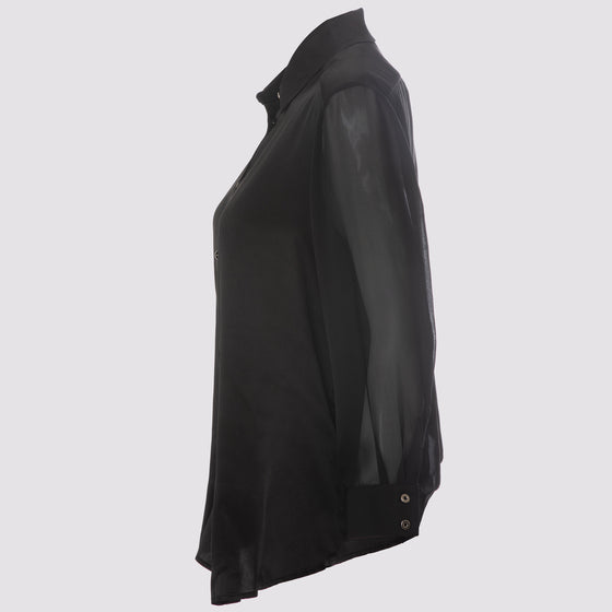 side view of the flight shirt by inlarkin in black showing the sheer sleeves and button detail at sleeve