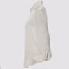 side view of the flight shirt by inlarkin in white showing the sheer sleeves and button detail at sleeve