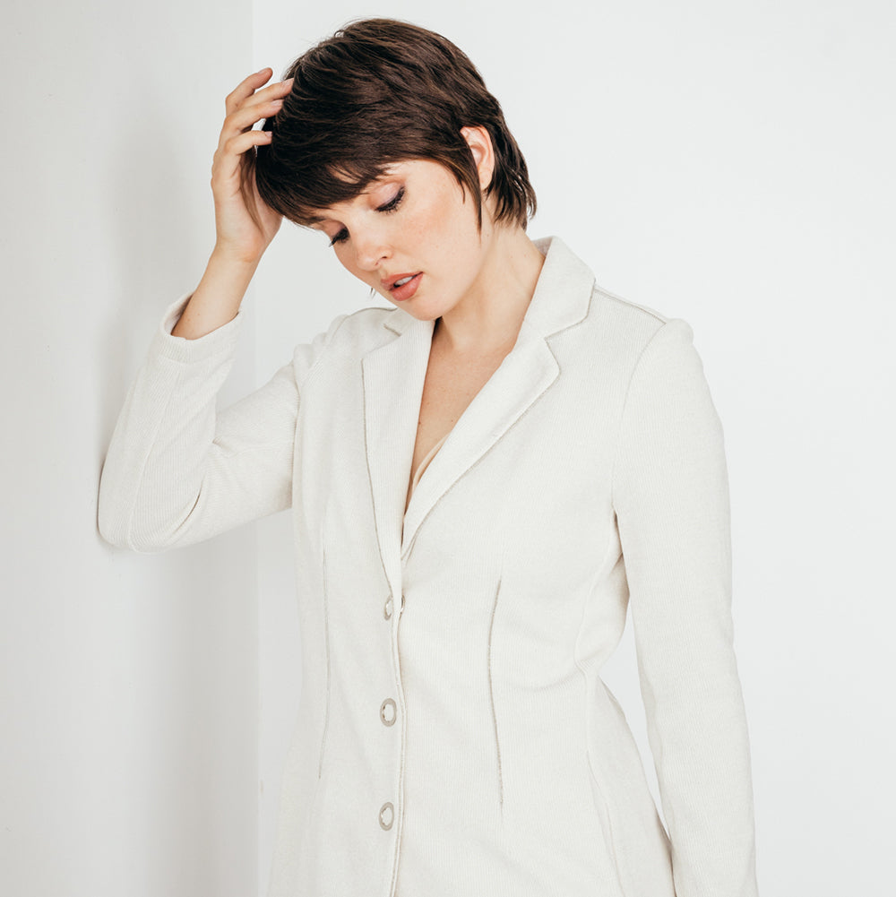  woman wearing the white sarah blazer by inlarkin showing the fabric and trim details