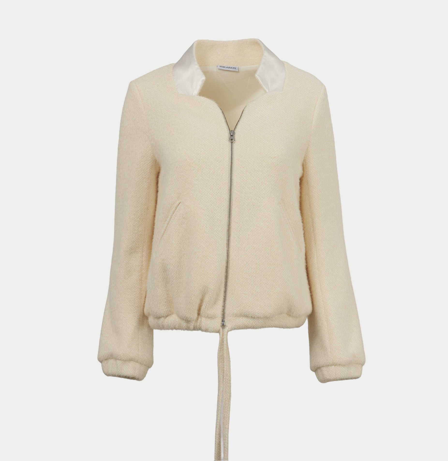 the larkin jacket in cream by inlarkin with a zipper front and tie waist on an off-white background