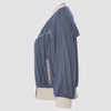 the side view of the lauren bomber in blue by inlarkin showing the front piping, pocket and  back vent details