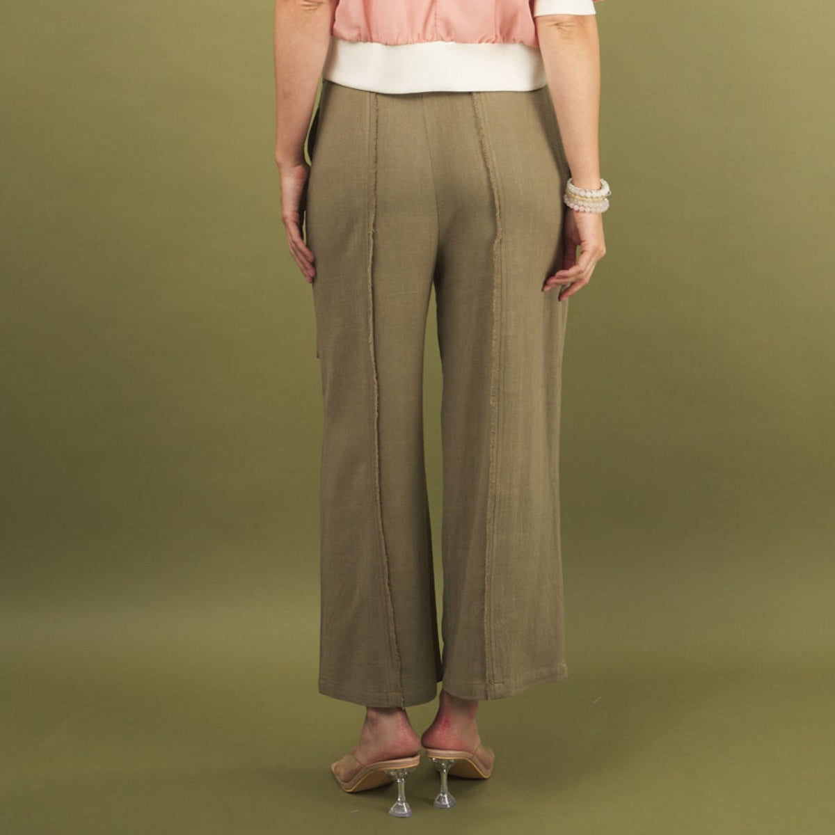 the linen fray pant in green sage back view with frayed seams detail