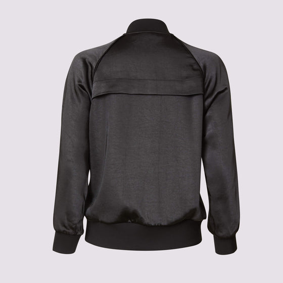 back view of the olivia beauty bomber jacket in black showing the fabric sheen and back vent detail