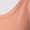 detail view of the variegated tank in coral  by inlarkin showing the fabric and sateen piping around the neckline and armhole