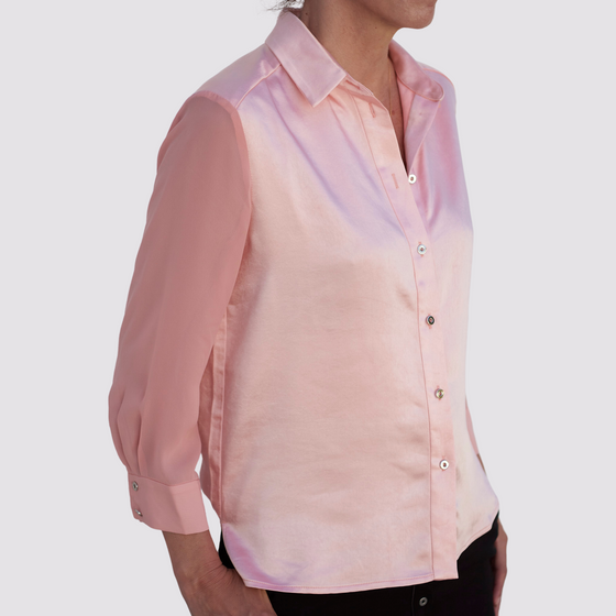 side view of the coral aliferous shirt by inlarkin detailing the back flap of fabric and sheer sleeves