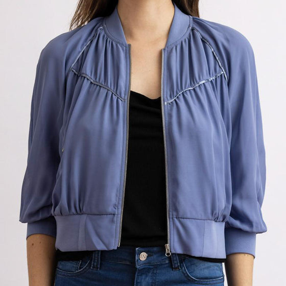 beauty bomber jacket in blue by inlarkin front view showing the piping and zipper detail