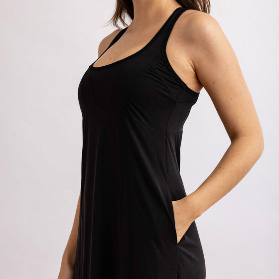 top view of the front of the wingspan dress by inlarkin in black showing the pocket and fitted top detail